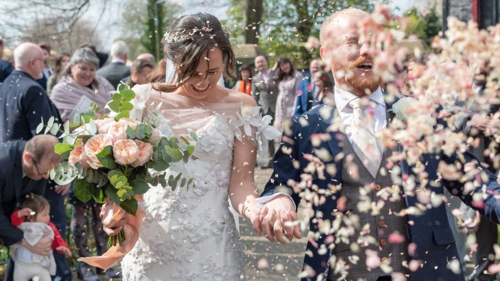 couple walking with a splash of confetti